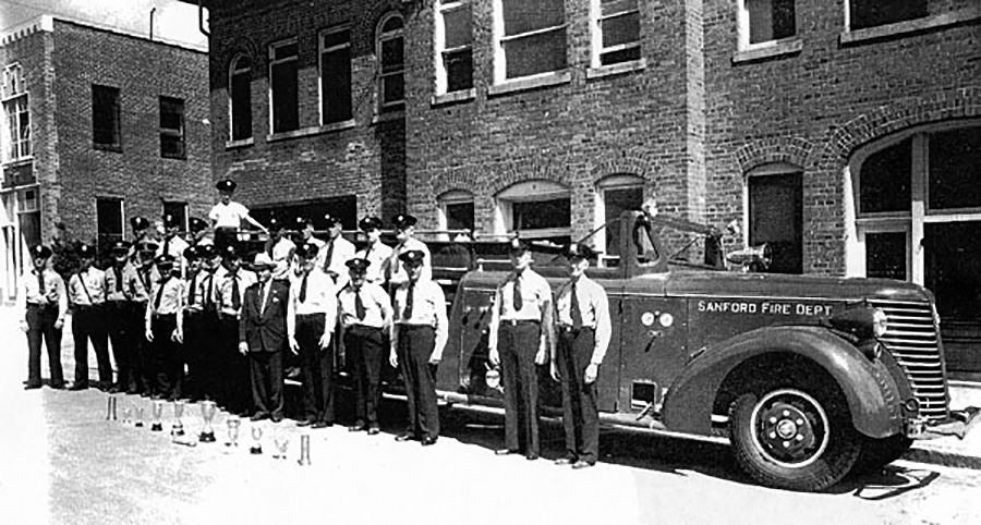 firemen by firetruck 